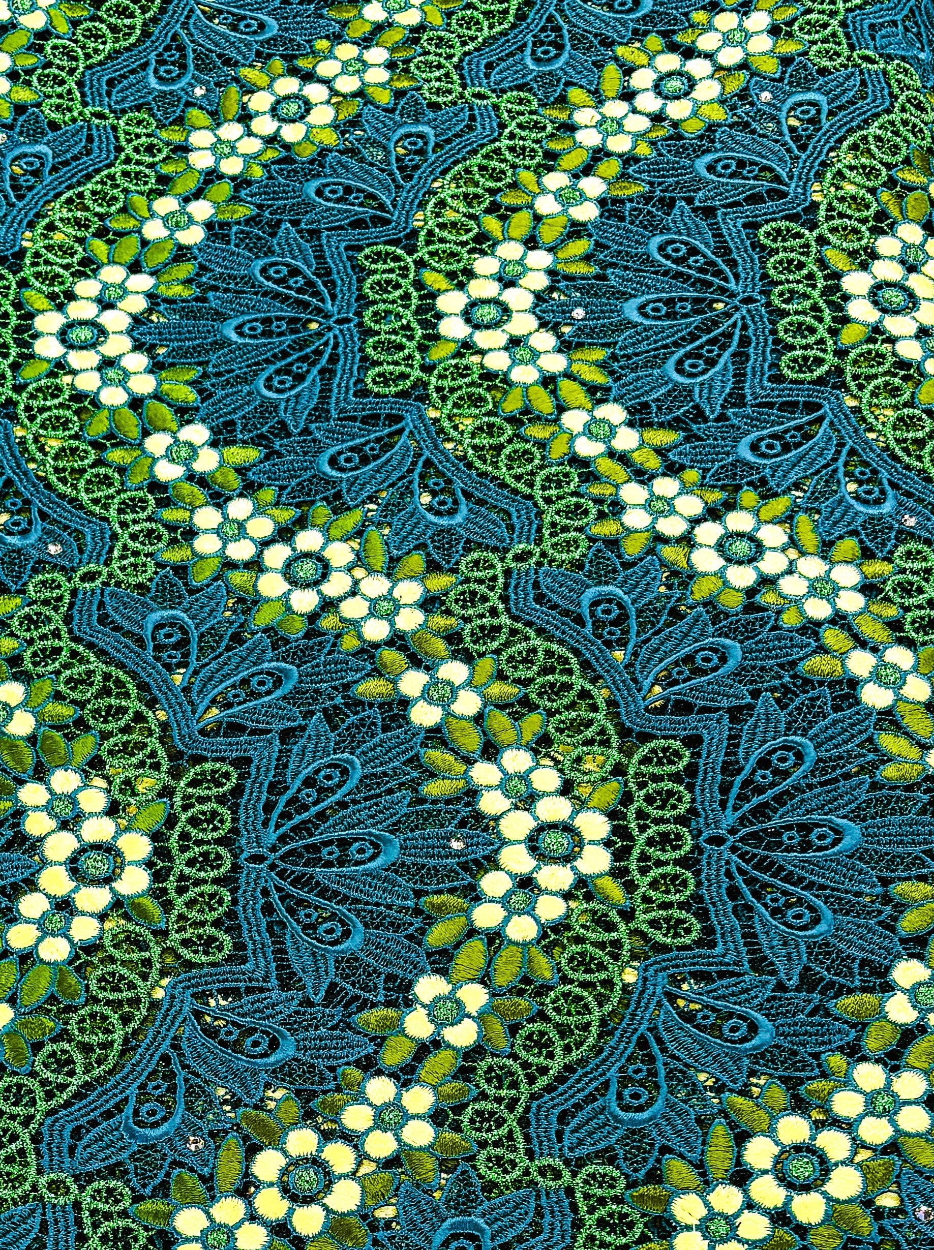 Decorative pattern Guipure lace with blue, green, and white colors on a textured background